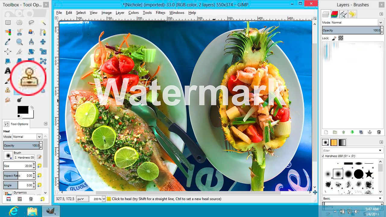 Removing watermark in GIMP using clone stamp tool..