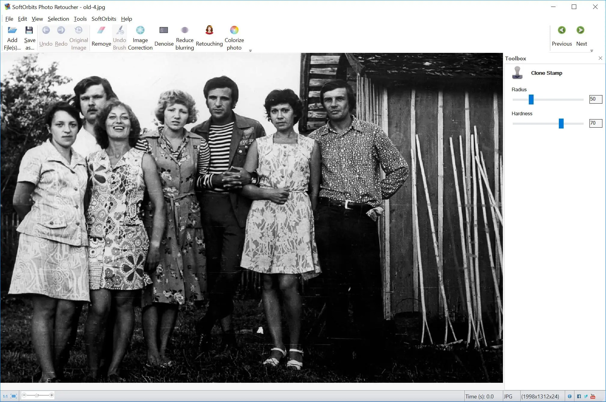 Restore damaged parts of old photo manually.
